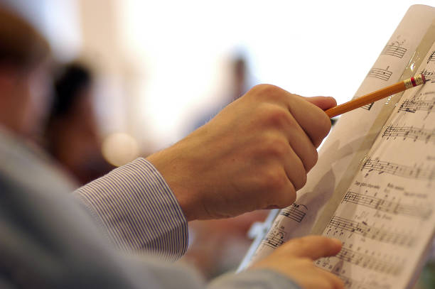 istock Two people are studying a musical score 874768958