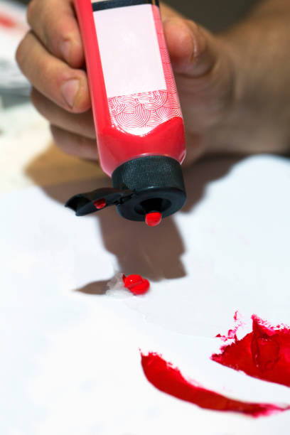 istock Female artist mixing red color 874772576
