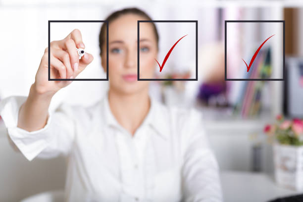 istock business woman checking mark on checklist 874772744