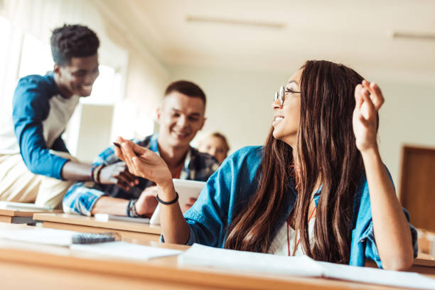 istock student girl talking to classmates 874776284