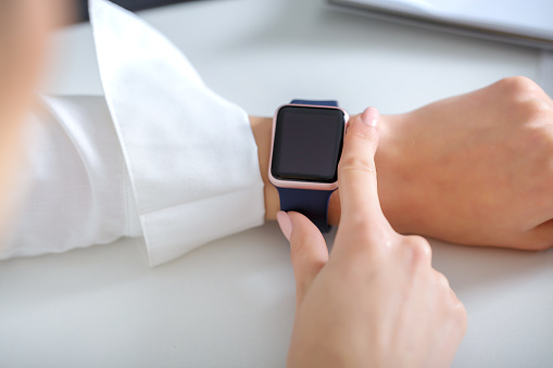 business woman using  smartwatch and working   in  office