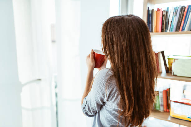 istock woman drinking a coffee at home 874779404