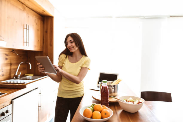 istock woman cooking in the kitchen using the tablet 874779502