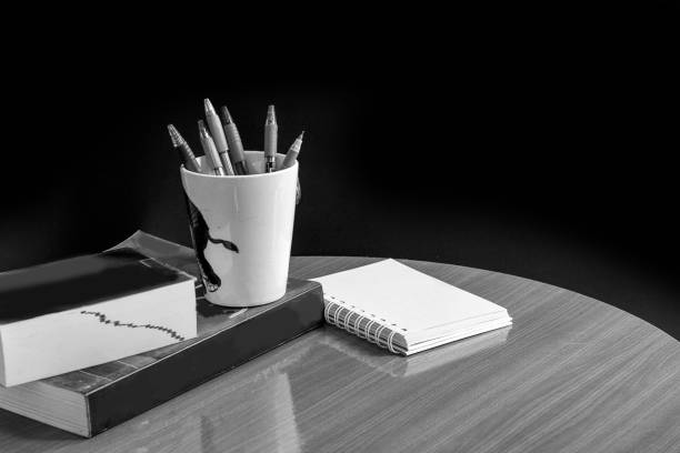 Education concept,book and pen on wood table and black background,