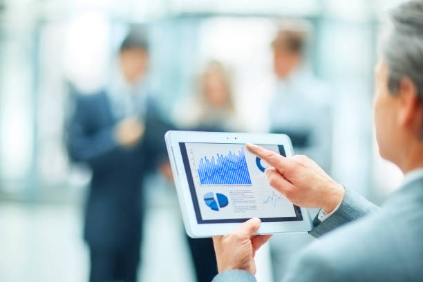 istock a successful businessman with financial graph on background in office 874780534