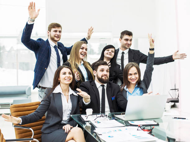 istock business team with their hands up and voting for decision-making near the desktop 874784326