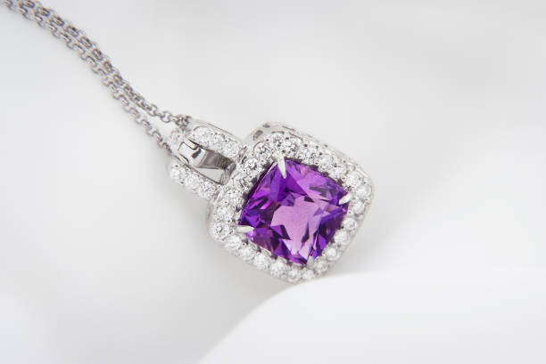 White gold pendant with rose violet amethyst and diamonds on soft  blurred background White gold pendant with rose violet amethyst and diamonds on soft  blurred background pendant photos stock pictures, royalty-free photos & images