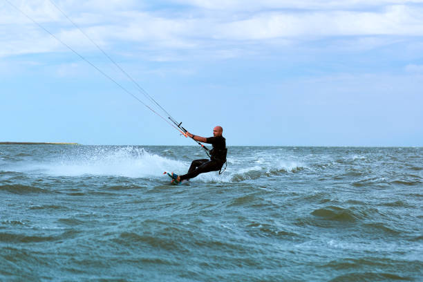 Kite Surfing on waves at sea in summer.