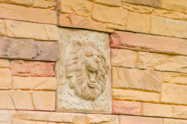 istock Lion sculpture vintage decoration on the wall. 874787462