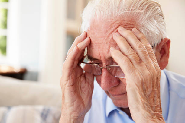 istock Senior Man Sitting On Sofa At Home Suffering From Depression 874788182
