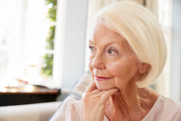 istock Senior Woman Sitting On Sofa At Home Suffering From Depression 874788704