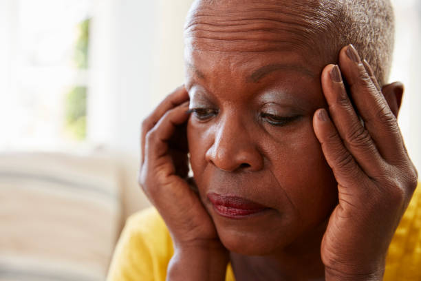 istock Senior Woman Sitting On Sofa At Home Suffering From Depression 874789102