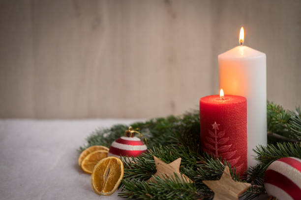 Christmas ornaments with snow, pine tree and candles stock photo