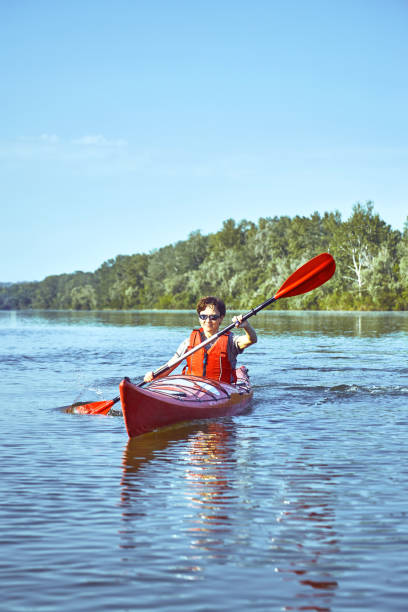 istock A canoe trip along the river along the forest in summer. 874789384