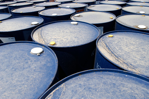 Many blue oil drums