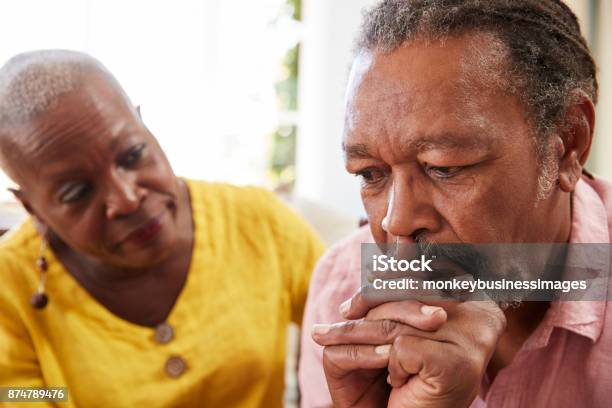 Senior Woman Comforting Man With Depression At Home Stock Photo - Download Image Now