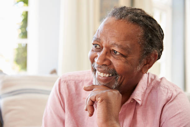 istock Smiling Senior Man Sitting On Sofa At Home 874791620
