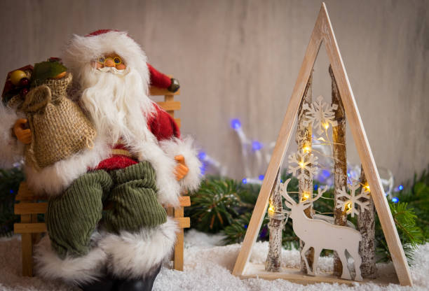 Christmas ornaments with snow, pine tree, Santa Claus and xmas lights stock photo