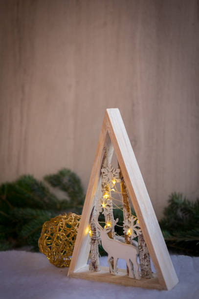 Christmas ornaments and xmas lights with snow, pine tree and cone stock photo