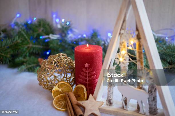 Christmas Ornaments And Xmas Lights With Snow Pine Tree And Candles Stock Photo - Download Image Now