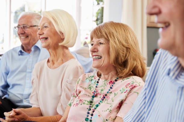 istock Group Of Senior Friends Relaxing On Sofa At Home 874793182