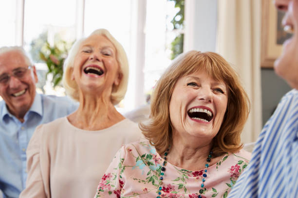 istock Group Of Senior Friends Relaxing On Sofa At Home 874793184