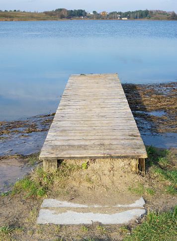 Wooden rustic bridge leads to nowhere conceptual landscape