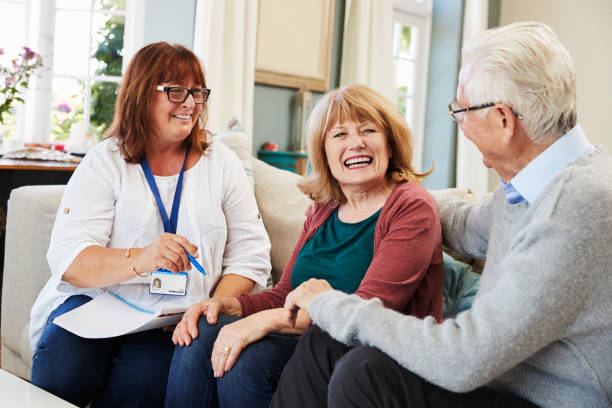 istock Female Support Worker Visits Senior Couple At Home 874793772