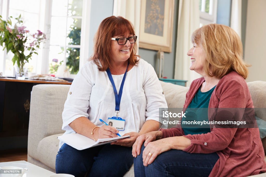 Female Support Worker Visits Senior Woman At Home Social Services Stock Photo