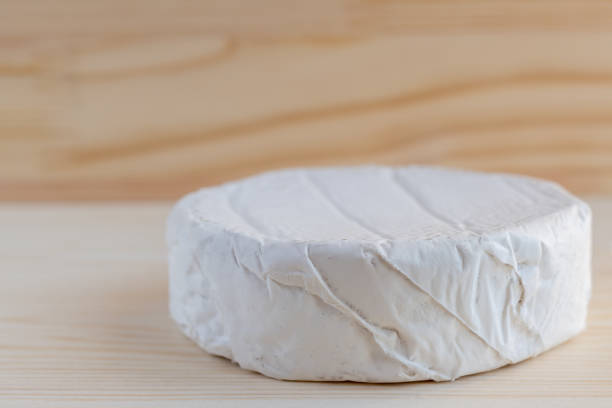 istock Camembert or brie cheese on wooden background 874793994