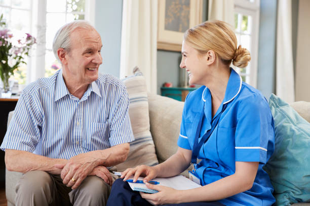 Female Community Nurse Visits Senior Man At Home Female Community Nurse Visits Senior Man At Home social services stock pictures, royalty-free photos & images