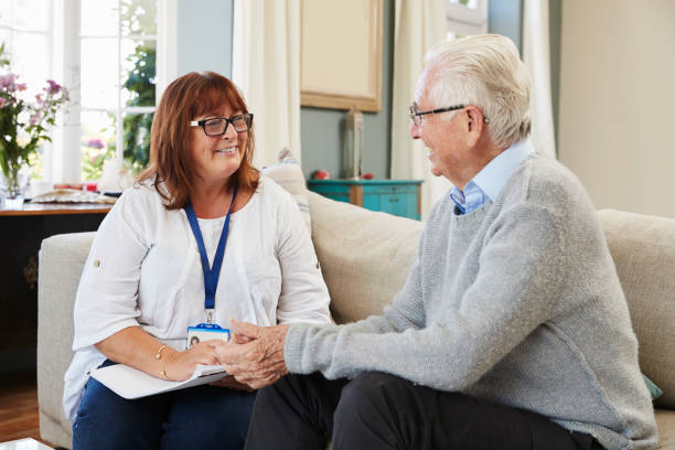 Female Support Worker Visits Senior Man At Home