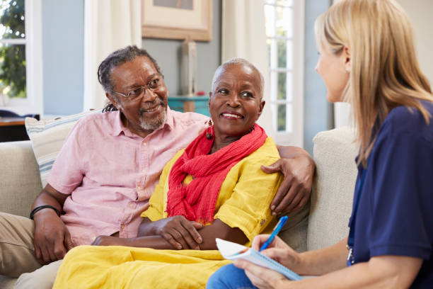istock Female Support Worker Visits Senior Couple At Home 874799584