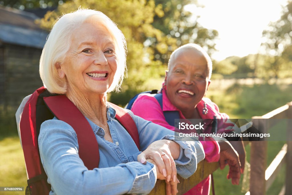 Portrait Of Two Female Senior Friends Hiking In Countryside Senior Adult Stock Photo
