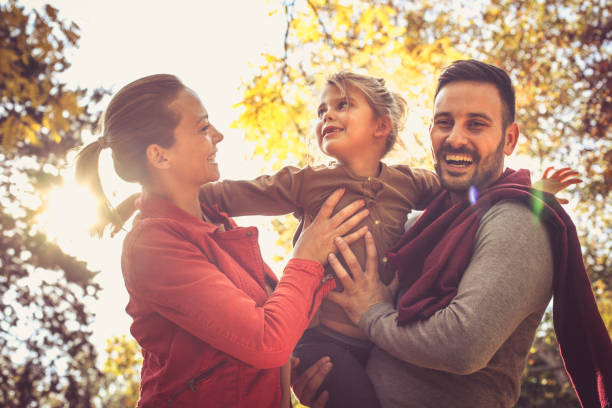 istock Smiling young parents walking with daughter. 874804010