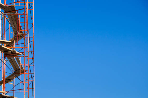 istock scaffolding around the building under construction against a bright blue sky 874804056