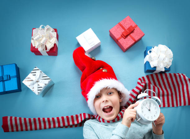 istock Smiling baby on red blanket with presents 874809822