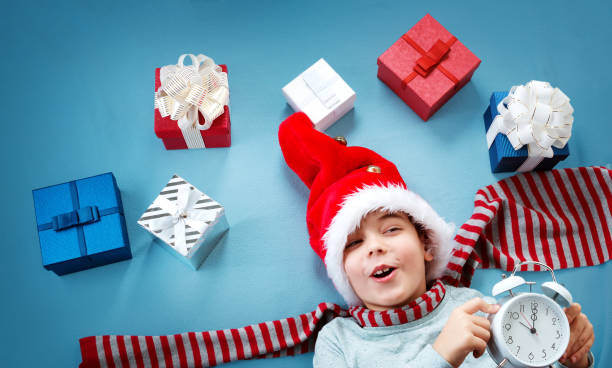 istock Smiling baby on red blanket with presents 874809896