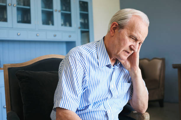 istock Senior Man Sitting In Chair At Home Suffering From Depression 874810036
