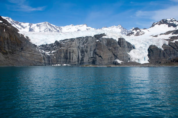 istock view of glacier and mountain range with blue sky 874810316