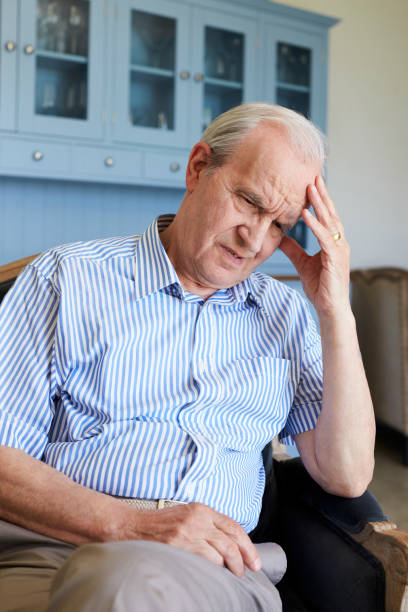 istock Senior Man Sitting In Chair At Home Suffering From Depression 874810686