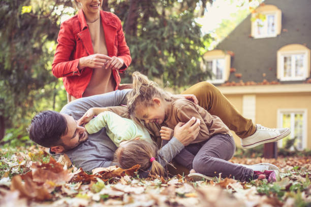 istock Daughters tickling father , playing with parents. 874811276