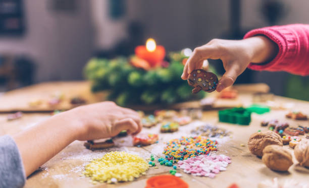 istock kids hands decorating christmas cookies together 874814236