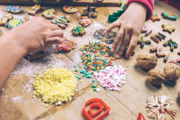 istock kids hands decorating christmas cookies together 874814426