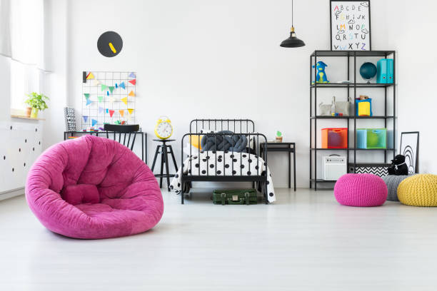istock Pink pouf in kid's room 874815408