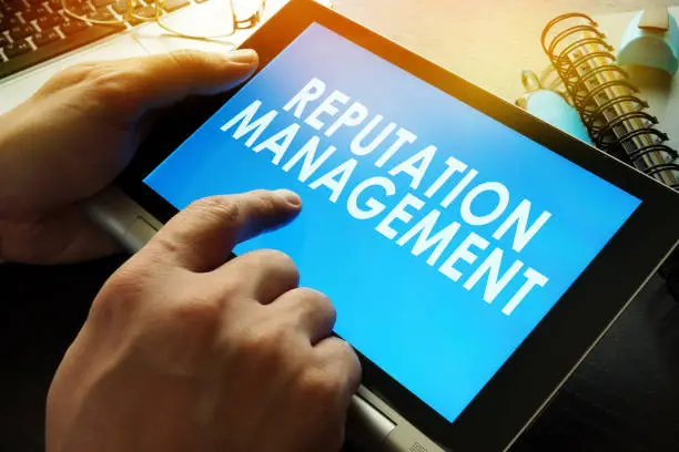 Photo of Reputation management on a screen of tablet.