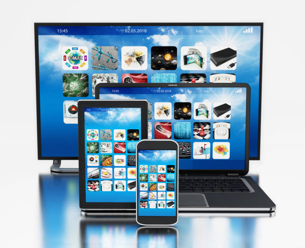 Smart TV, smartphone, digital tablet and laptop computer on reflective surface