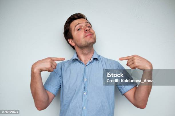 Selfsatisfied And Proud Caucasian Young Man Looks Forward Stock Photo - Download Image Now
