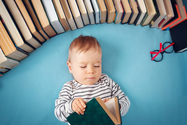 istock One year old baby with spectackles and books 874830104