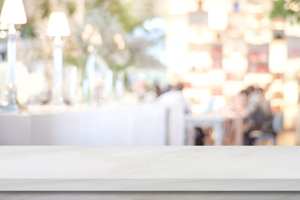 istock Empty white marble over blur cafe background, product and food display montage 874835606
